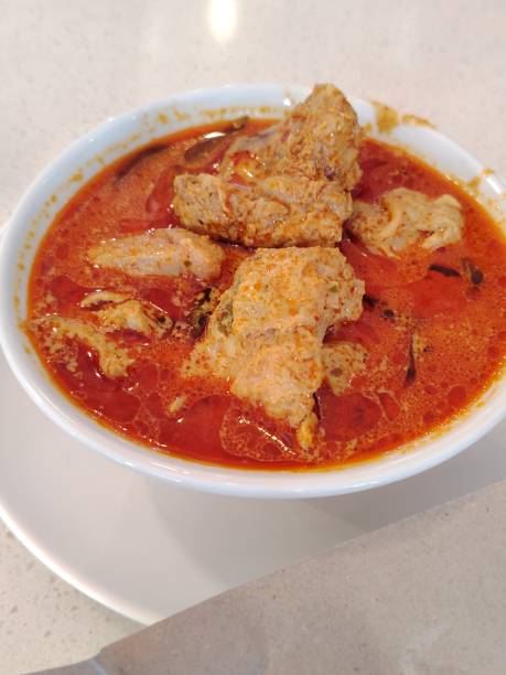 istock A bowl of curry chicken on a table 2167273748