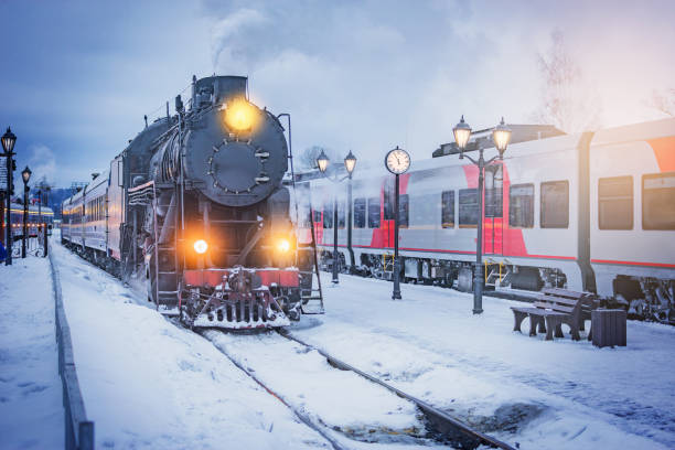 istock Retro christmas steam train approaches to the plarform. 2167274368