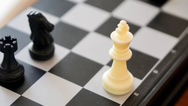 istock chess piece on a chessboard in an office with 2167274791