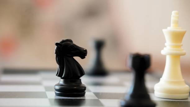 istock chess piece on a chessboard in an office with 2167274810