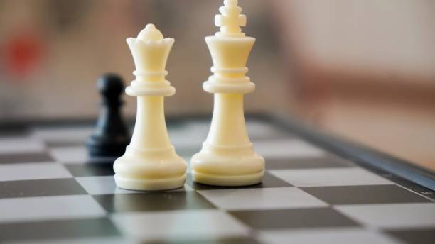 istock chess piece on a chessboard in an office with 2167274830
