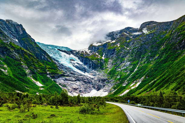 The largest glacier in continental Europe, Jostedalsbreen, is located in the mountains. Cold summer in Norway. The highway winds through a narrow hollow. Jostedalsbreen National Park.