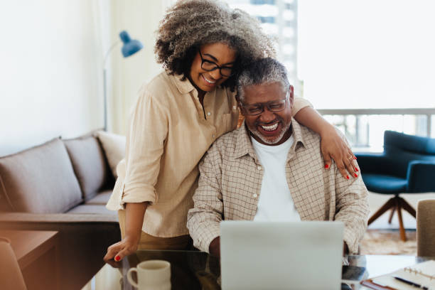 istock Affectionate senior couple at home using laptop, smiling and enjoying quality time together 2167277100