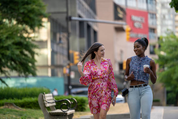 Young women walk on paved pathway, Vancouver