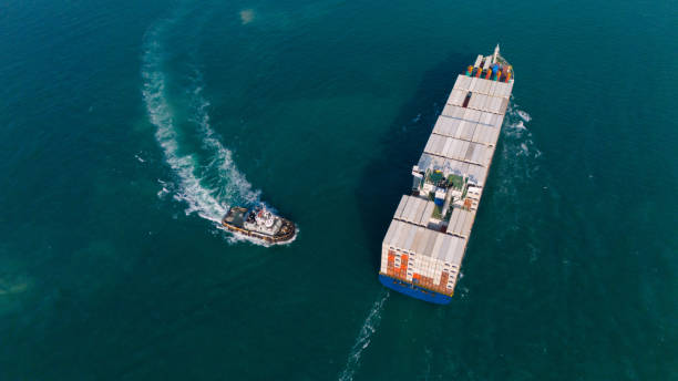 istock Logistics and container loading by large barges by sea in a harbor full of containers waiting to be transported 2167282258