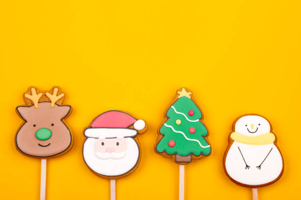 Christmas Themed Iced Cookies on Yellow Background