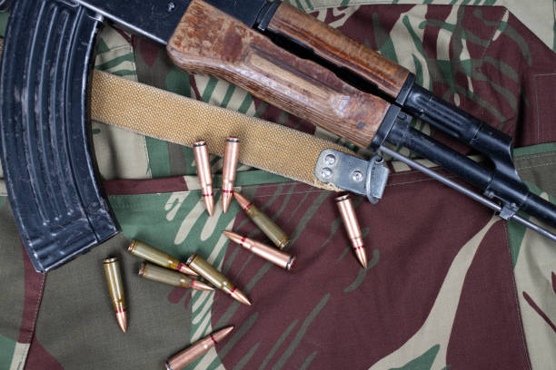 istock AK assault rifle on camo uniform background 2167283314