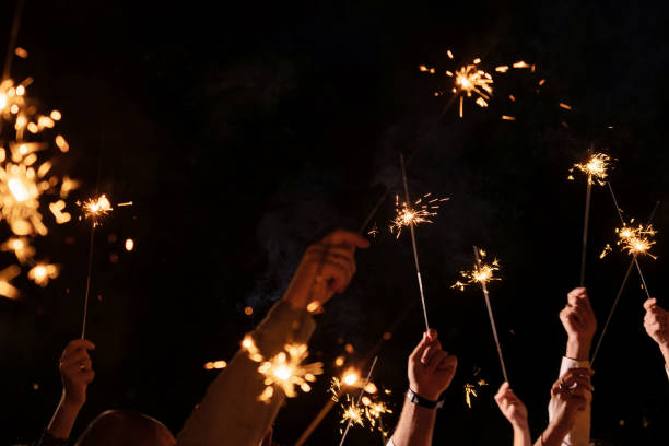 istock A group of people raised their hands, holding sparklers. Night. Celebration 2167287525