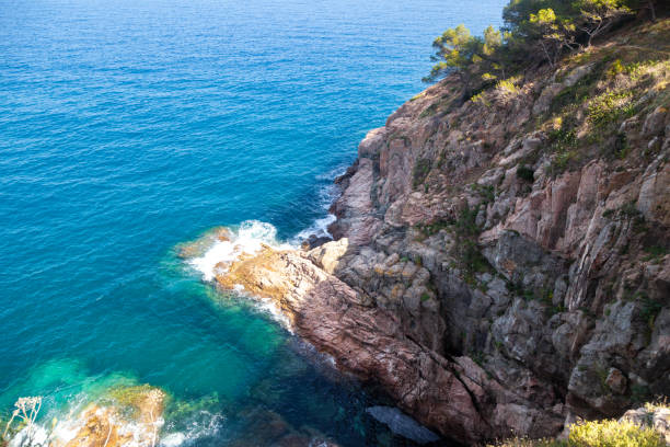 View of the blue sea from a high cliff. Ideal for travel and tourism content.