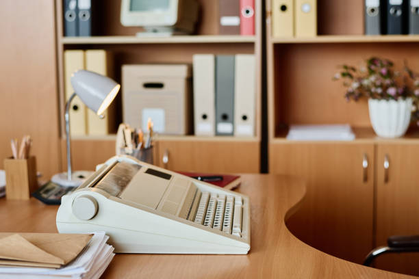 istock Vintage Office Setting with Typewriter and Desk Lamp 2167295144