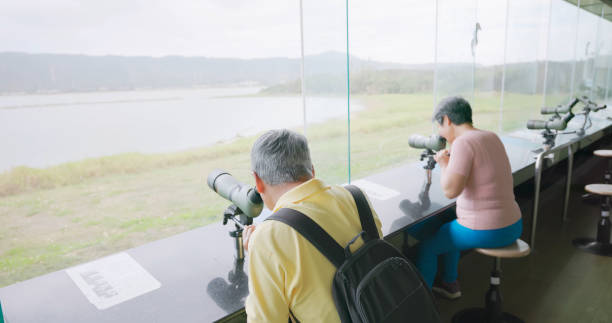 asia older couple telescope birding