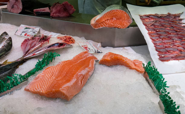 istock Fresh salmon fillet being arranged at a fish market.2 2167297797