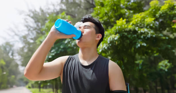 istock asian male drink water park 2167298374