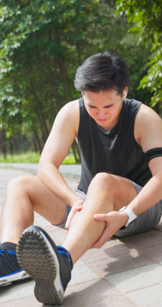 istock asian man sporting calf cramping 2167298713