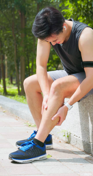 istock asian man sporting calf cramping 2167298740