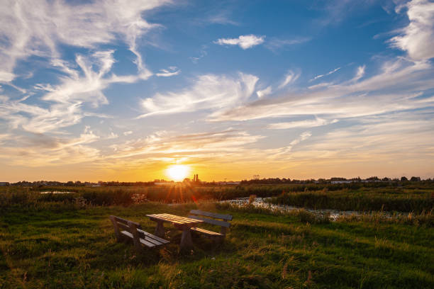 Beautiful sunset sky over a hiking rest area in the Dutch polder landscape near Gouda, The Netherlands.