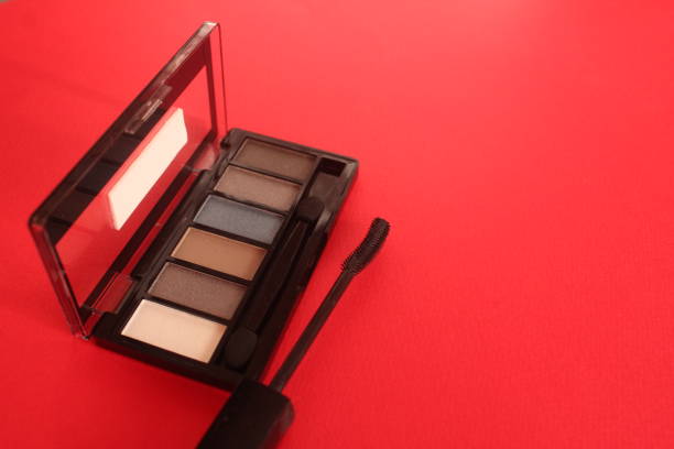 Eye Makeup Eye Shadow And Mascara On Red Background With Space For Text Copyspace.