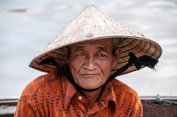 Hoi An, Vietnam - nov 21, 2013: elderly man with his typical Vietnamese hat in Hoi An