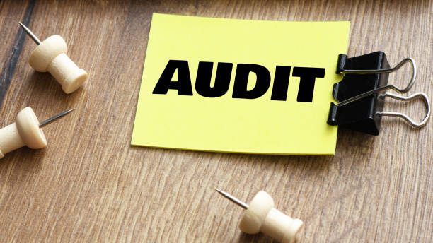 istock AUDIT word on a small piece of paper. 2167302122