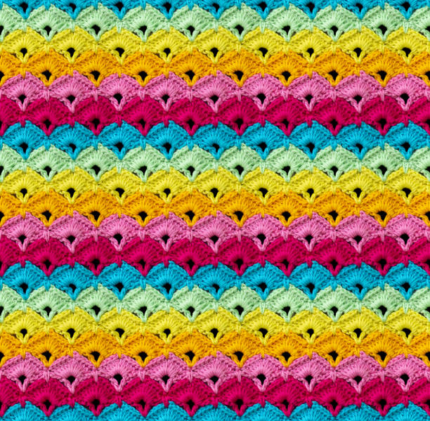istock Bright seamless knitted texture. The pattern in the form of rhombus is crocheted with multi-colored threads. 2167303297