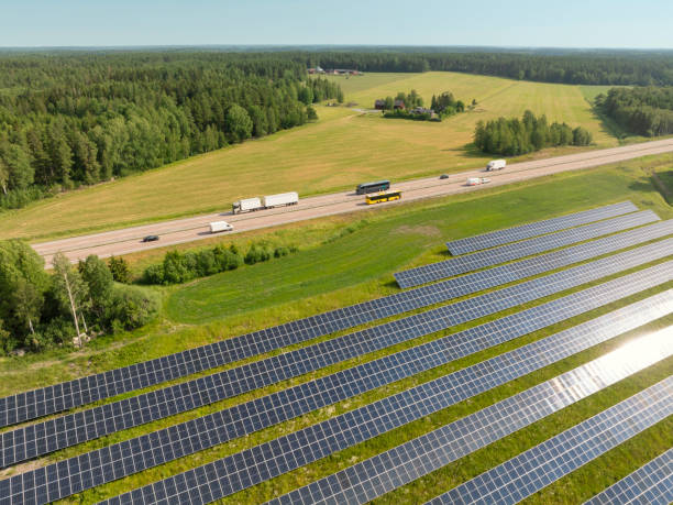 istock Trucks and buses on the highway next to a solar farm 2167305516
