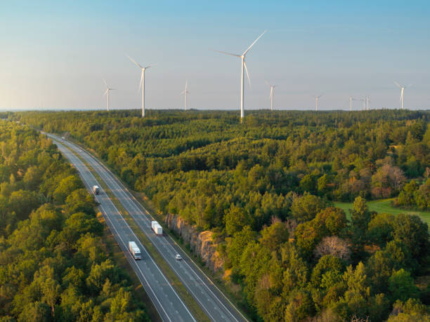 istock Highway in a forest landscape with wind turbines 2167305592