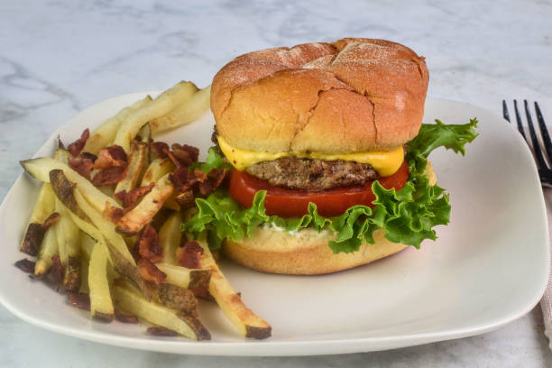istock cheese burger  with fries top with bacon 2167306936