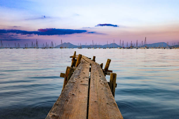 Sailboat masts standing tall against a dramatic cloudy sky, creating a serene and captivating seascape. Santander, Cantabria, Spain, Europe.