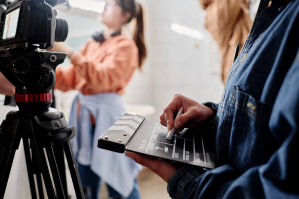 Filming Scene with Clapperboard and Camera Crew