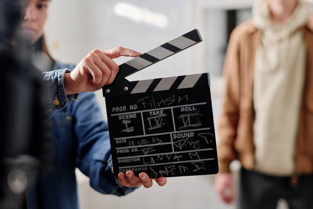 istock Filmmaking Scene with Film Clapper and Crew Members 2167307384