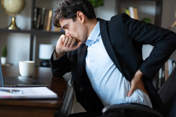 istock A businessman who works too much in the office has a backache 2167310202