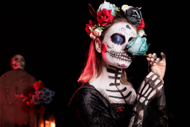 istock Mysterious lady enjoying fresh flower scent, celebrating Dia de los Muertos 2167312891
