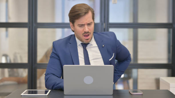 istock Young Businessman with Spinal Injury having Back Pain at Work 2167313917