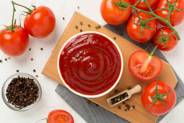 istock Delicious ketchup with spices and tomatoes on concrete background, top view 2167316461