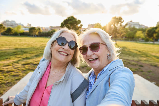 istock Two happy senior women taking selfie while visiting city park 2167316992