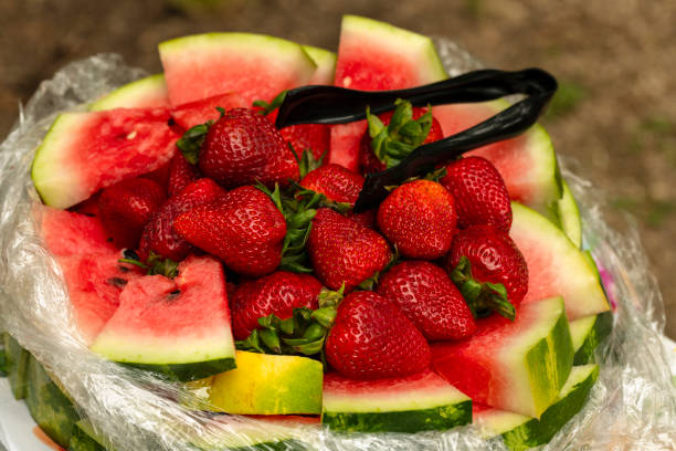 Stock photo showing a healthy eating breakfast fruit bowl of juicy, ripe sliced watermelon and fresh papaya. Fruit salad breakfast buffet, with healthy fruit and vegetables.
