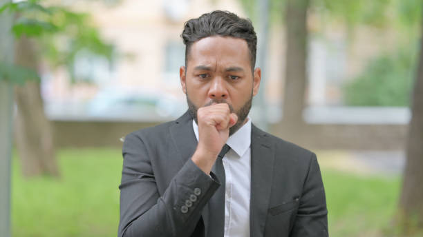 istock Sick Mixed Race Businessman Coughing Standing Outdoor 2167319302