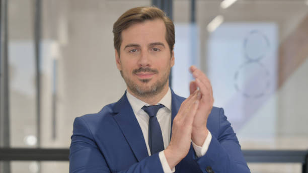 istock Portrait of Young Businessman Clapping for Team 2167319785