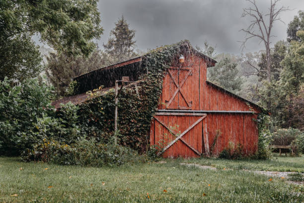 Landscape view of a barn in the middle of a rain storm