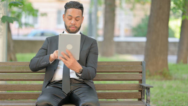 istock Businessman Doing Video Chat on Tablet Outdoor 2167320635
