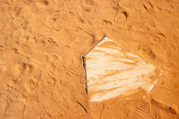 A baseball or softball home plate in the dirt in the infield.