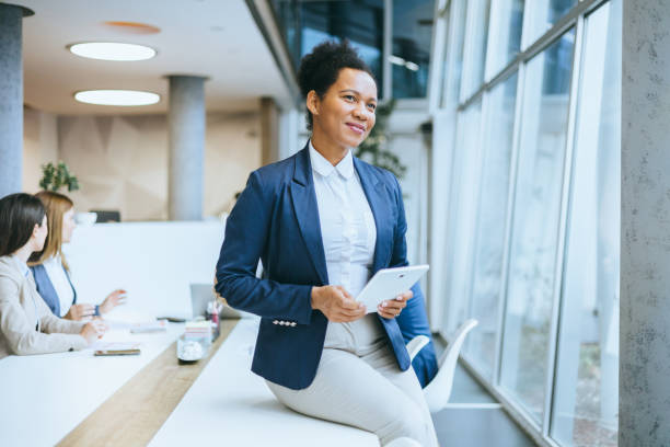 istock Smiling female executive with digital tablet in office 2167322796