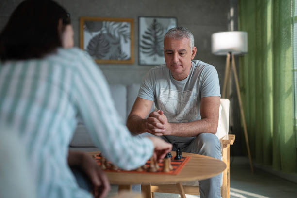 istock Hobbies over 50. Friends Playing Chess. Board Games. 2167323144