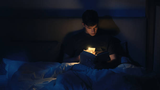 istock Nighttime Reading book man in Bed Cozy Relaxation 2167323368