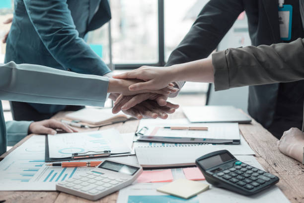 istock Businessmen holding hands having documents with graphs and financial charts, concept of business agreement together, close-up image. 2167325209