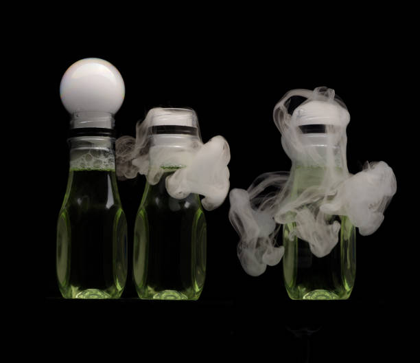 istock Smoke bubbles bursting creating unique shapes and patterns around small plastic bottle with black background 2167329743