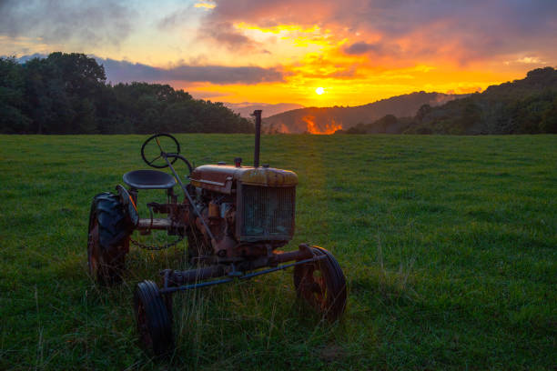istock Old tractor with a beautiful sunrise 2167333936