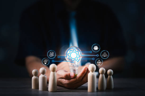 istock A man is holding a light bulb with a group of people around him 2167334376