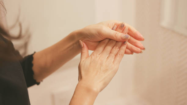 istock Woman apply hand cream on her hands at Bathroom 2167337436