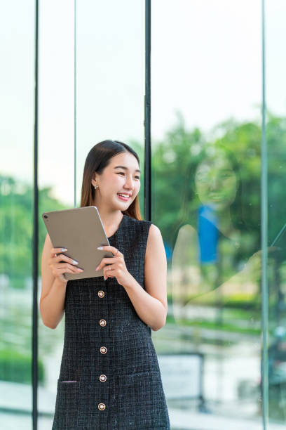 istock Young Businesswoman Using A Tablet, Looking Away Smiling 2167343089